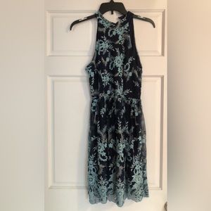 Knee length high neck dress.